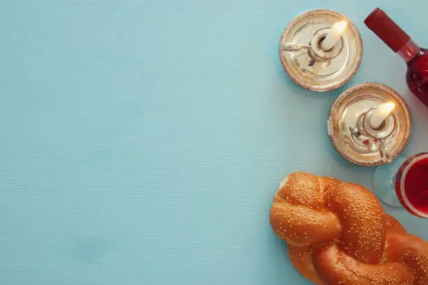 shabbat image. challah bread, wine and candles. Top view.