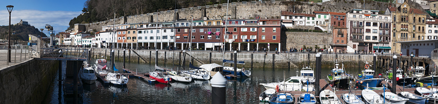 San Sebastian, Spain, 01/27/2017: boats in the port and view of the skyline on the seafront of Donostia San Sebastian, the coastal city on the Bay of Biscay