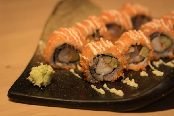 istock close up of sushi rolls on black plate 693340318