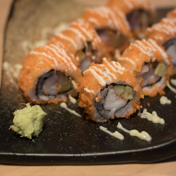 istock close up of sushi rolls on black plate 693340380
