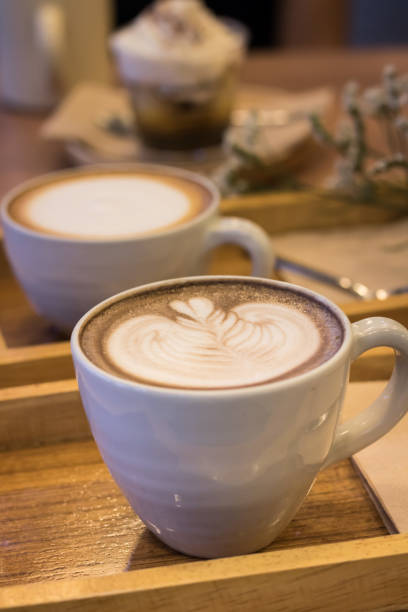 istock close up of a coffee cup on wooden background 693344882