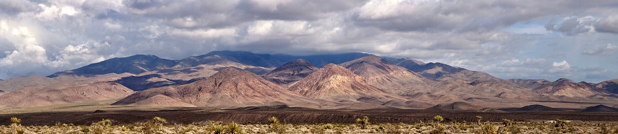 Sierra Nevada desert with mountains and dramatic sky.