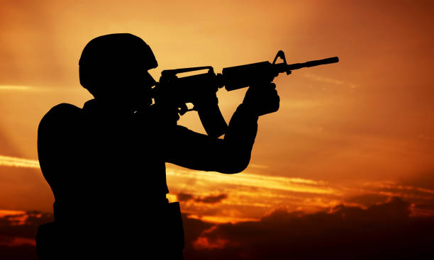 istock Soldier shooting with his weapon, rifle at sunset. War 693352868