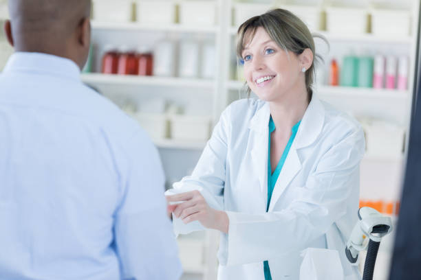 istock Friendly Caucasian pharmacist talks with male customer 693355996