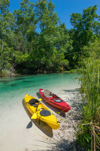 istock Two Kayaks on Sandy River Bank 693356238
