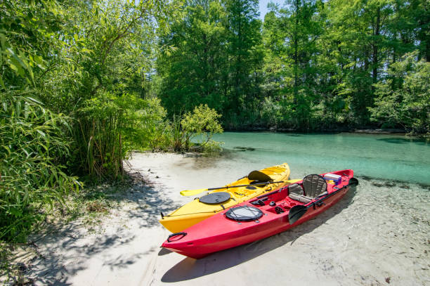 istock Two Kayaks on Sandy River Bank 693357094