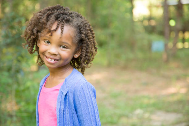 istock African descent, little girl outdoors in spring or summer. 693359348