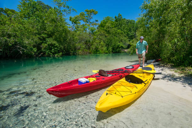 istock Two Kayaks on Sandy River Bank 693359654