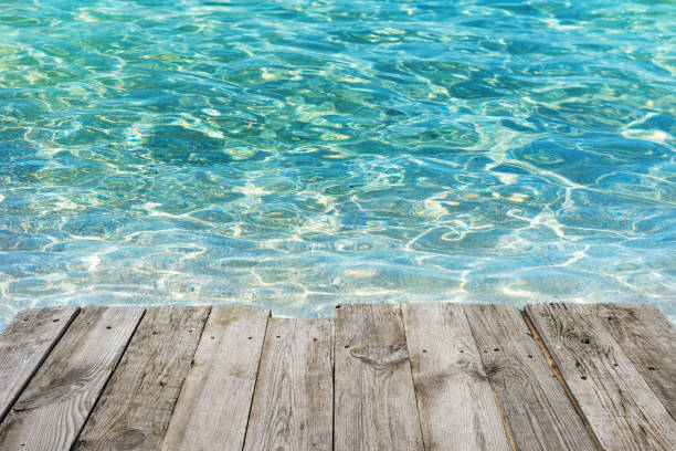 istock Empty wooden table to tropical blue water background 693363076