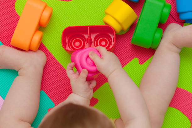 istock Toddler plays with building block 693363330
