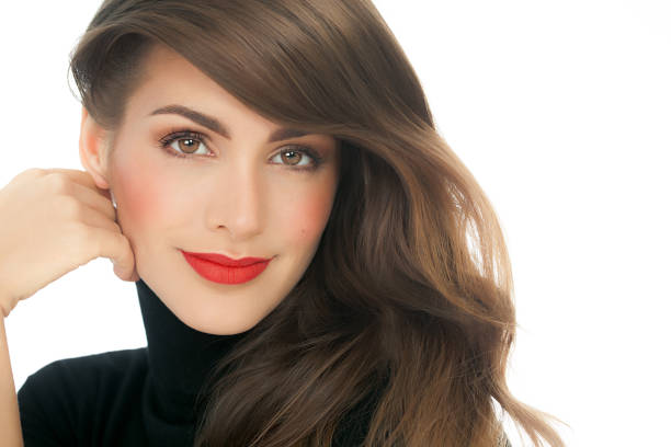 Beautiful European brunette woman with long hair and red lipstick.