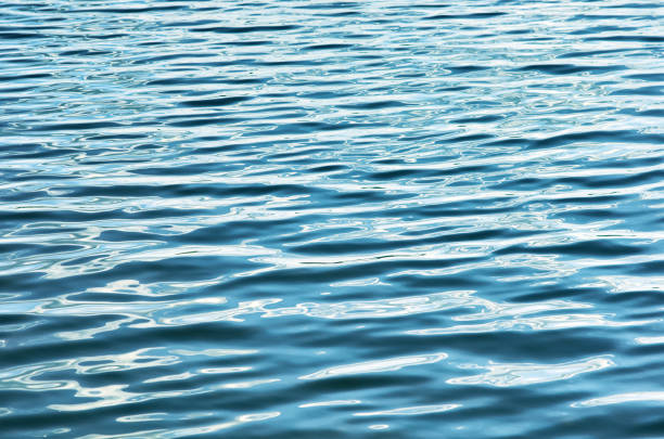 fondo superficie de ondulación azul agua - water wave sea tranquil scene fotografías e imágenes de stock