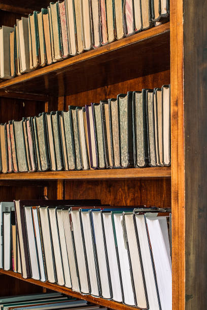 istock old books on an archival shelf of library. 693370388