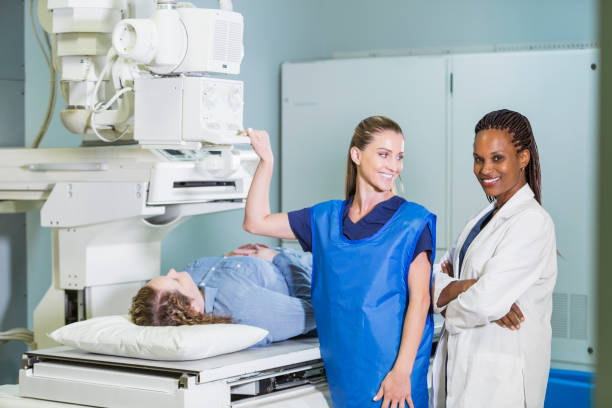 istock Female doctor and nurse with patient getting x-ray 693372864