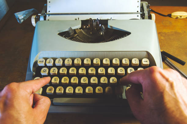 Typewriter Man typing on an old typewriter typewriter keyboard communication text office stock pictures, royalty-free photos & images