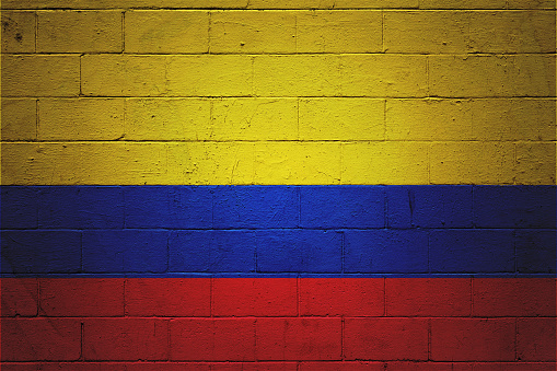 Flag of Colombia painted on a brick wall.