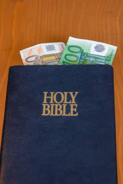 istock Bible, cross and money 693377686