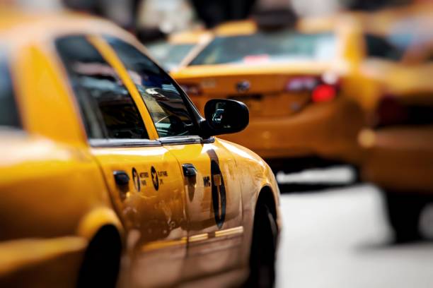Yellow cab speeds through Times Square in New York, NY, USA. stock photo