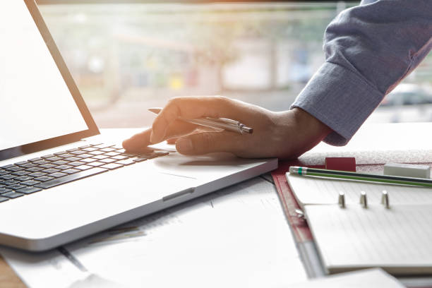 istock Business man working at office with laptop and documents 693380914
