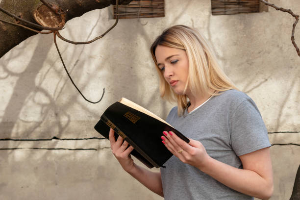 istock Girl reads the Bible 693380958