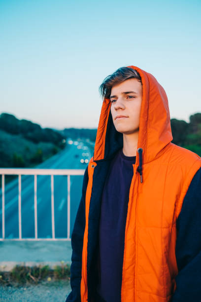 istock Casual young man by the highway 693384666