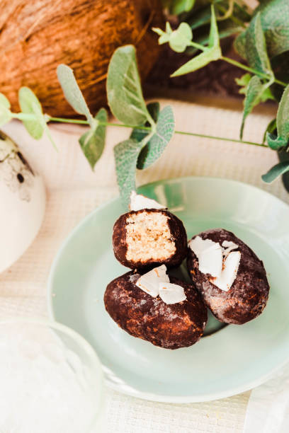 Homemade raw bounty candy, healthy vegan dessert, coconut in chocolate. Selective stock photo