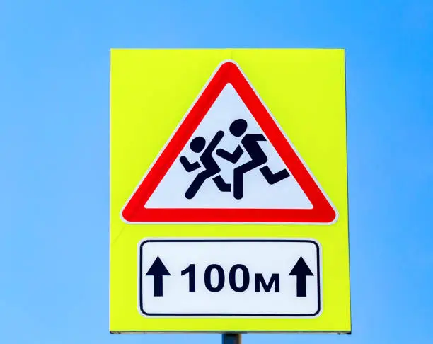 Photo of Road sign Warning Children on blue sky background