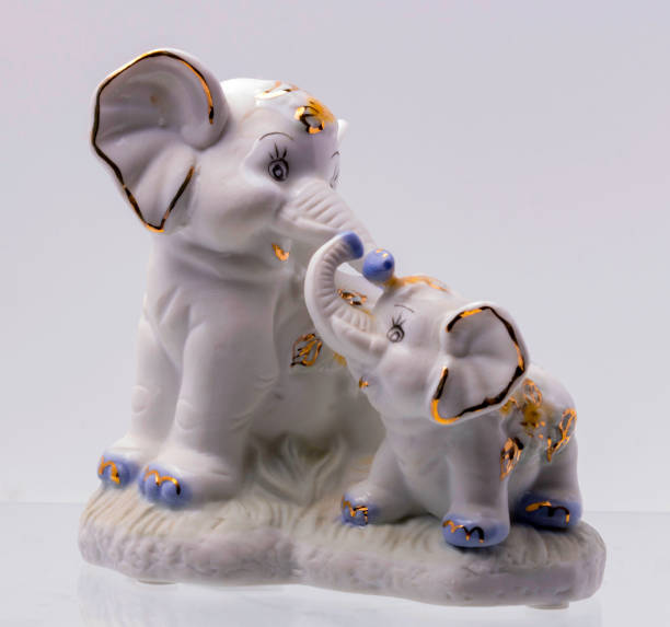 istock Figurine of Two Elephant on white Background 693391484