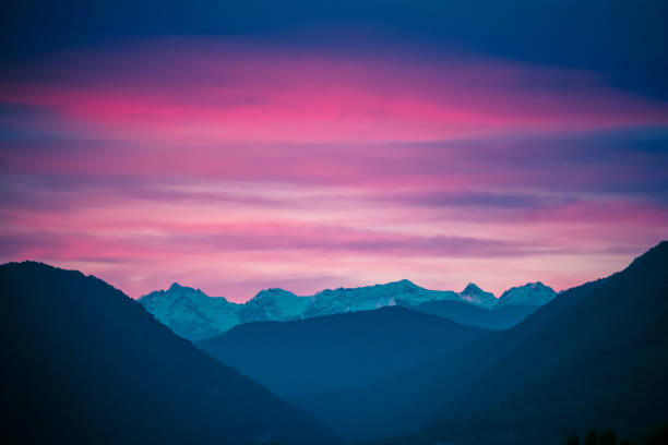 istock Fantastic mountain landscape on background of pink and a dramatic sunset 693394564