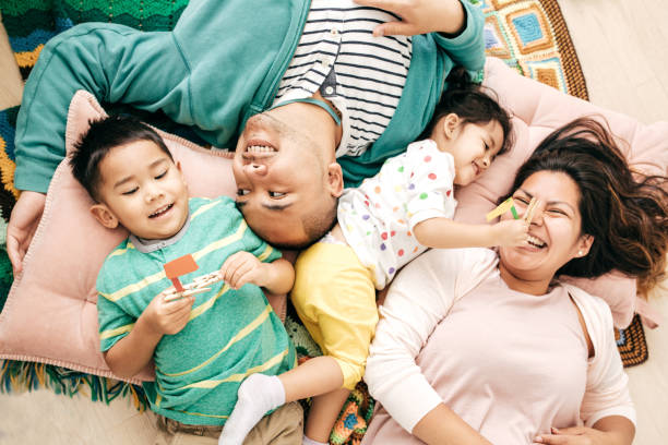relaxed parenting - asian ethnicity child four people couple imagens e fotografias de stock