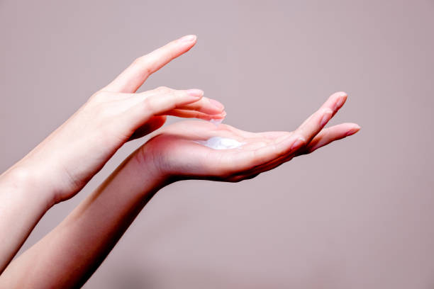 istock beautiful woman hands with cream 693400018