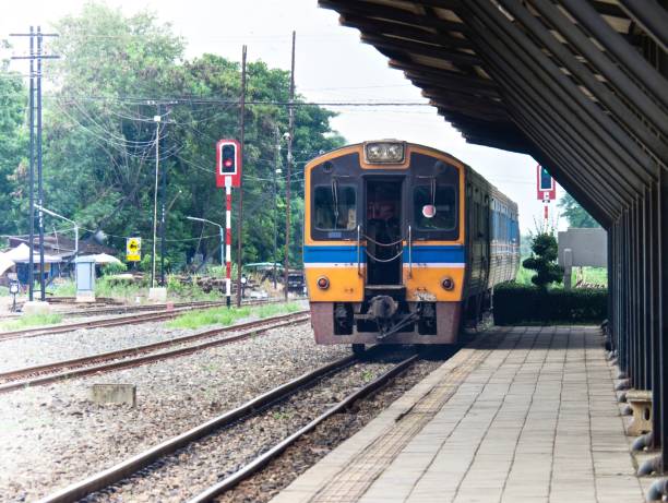 istock Yellow Train Leaving At Local Station 693400662