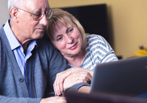 istock Happy senior couple using laptop at home. 693403900