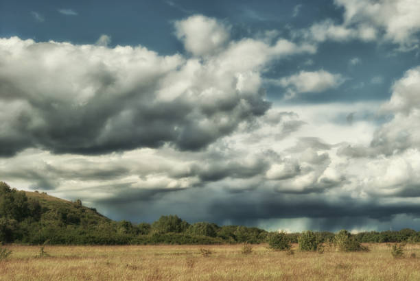 istock Storm clouds over the fields of the green valley 693404256