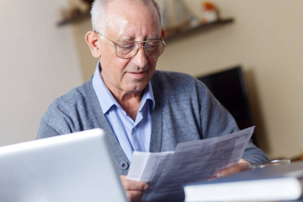 istock Senior couple checking their bills at home 693405608