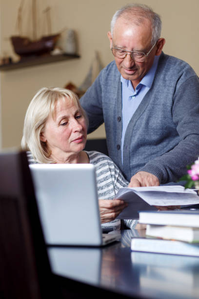 istock Senior couple checking their bills at home 693406548