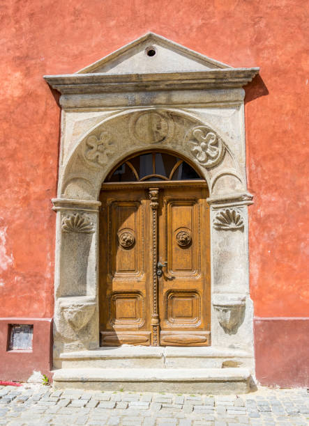istock Ancient wooden door in an ancient medieval house. Front exit to the street 693409412