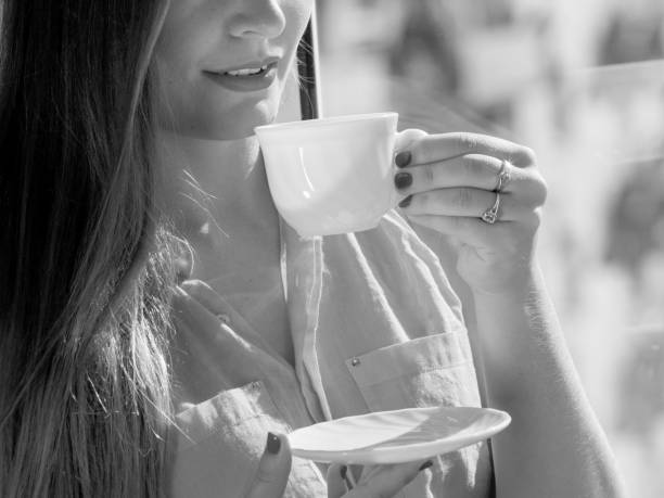 istock Woman looking through window, relaxing drinking coffee 693409836