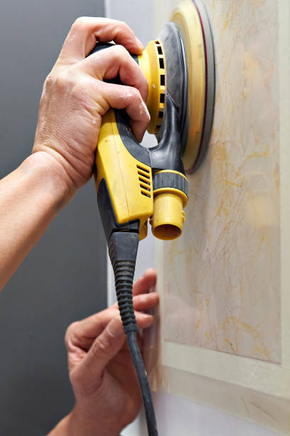 istock Grinding wall panel in repair of house 693413350