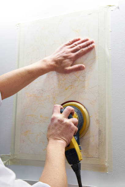 istock Grinding wall panel in repair of house 693413516