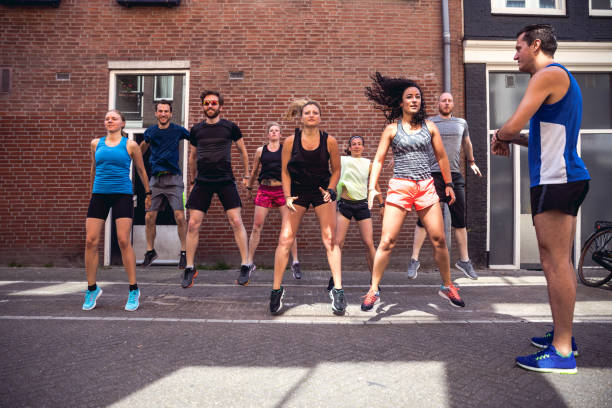 istock Urban runners crew squat in the streets 693415958
