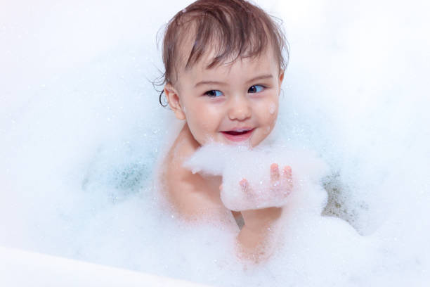istock cute baby is swimming in bath 693416294