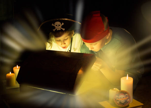 Cute girl and adventurous boy found a treasures. Happy young pirates. Childhood dreams. Cute girl and adventurous boy found a treasures. Happy young pirates. child casket stock pictures, royalty-free photos & images