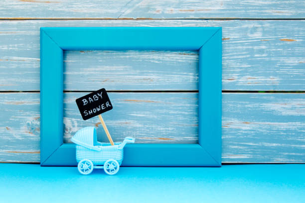 Baby Shower Toy Pram With Backboard Sign With Blue Frame And Wooden  Background Stock Photo - Download Image Now - iStock