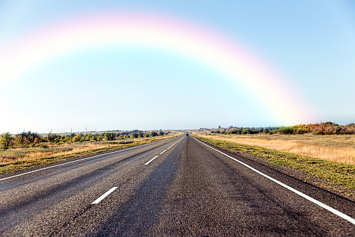Rainbow and paved road in the steppe