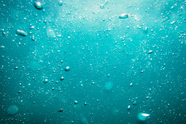 istock Underwater turquoise texture in ocean. Bubbles in tropical sea. 693426038