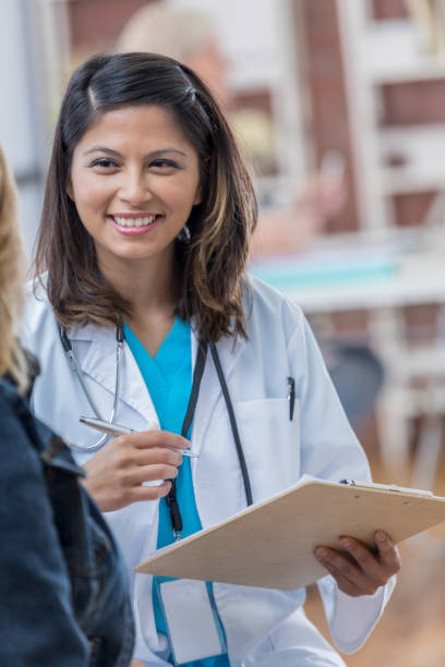 istock Female Asian doctor talks with new patient 693429104