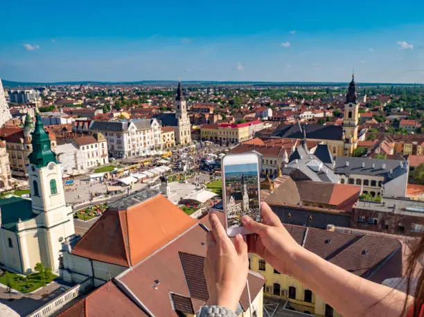 Photo of Tourist taking pictures from the City Hall Tower in Oradea, Romania