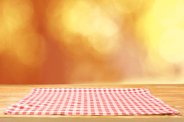 The checkered tablecloth on wooden table.