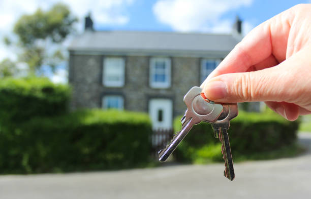 Keys to New Home Close up of keys to a house in the background house key photos stock pictures, royalty-free photos & images